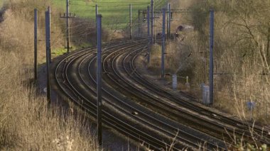 UK Commuter Train Travelling along the Railway Infrastructure