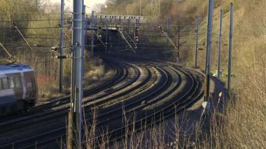 UK Commuter Train Travelling along the Railway Infrastructure