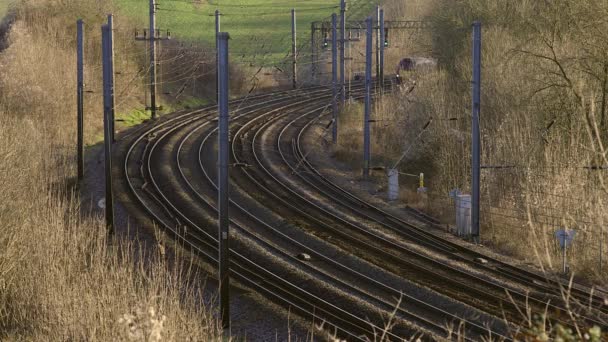 Британський Приміський Поїзд Подорожує Вздовж Інфраструктури Залізниці — стокове відео