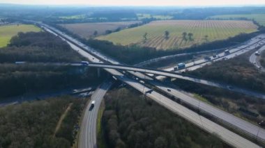 Vehicles Driving Along a Busy Motorway Interchange in the UK Aerial View