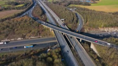 Vehicles Driving Along a Busy Motorway Interchange in the UK Aerial View