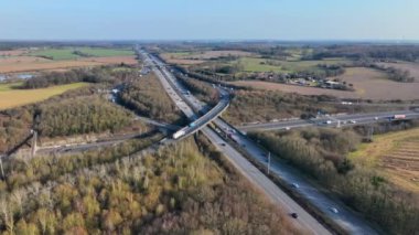 Vehicles at Rush Hour Driving Through a Freeway Intersection Aerial View