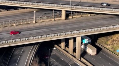 Vehicles at Rush Hour Driving Through a Freeway Intersection Aerial View