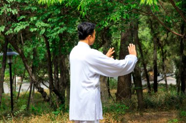 TANGSHAN - MAY 10: elderly practicing martial arts in a park on May 10, 2014, tangshan city, hebei province, China.