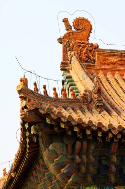 Temple eaves and beast sculpture, closeup of photo