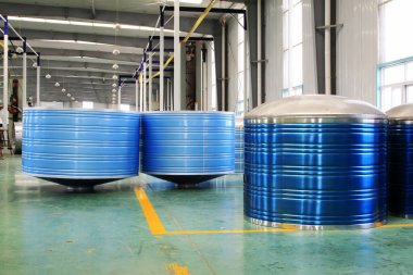 Blue stainless steel solar water heater in a production workshop 