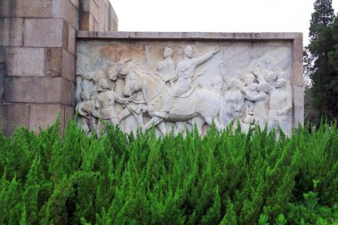 Shijiazhuang - May 5, 2017: reliefs on walls, outside a memorial hall, Shijiazhuang, Hebei, china clipart