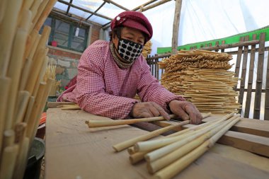 Luannan County - December 21, 2017: workers processing cover curtains in a handmade workshop, Luannan County, Hebei Province, China. This is the most important traditional handicraft industry in the local area