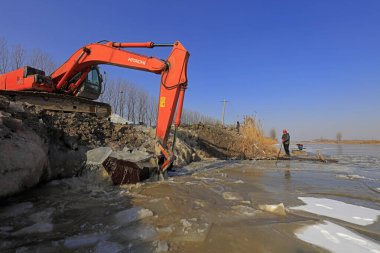 Luannan County - January 26, 2018: Excavator for ice in the field, Luannan County, Hebei Province, Chin