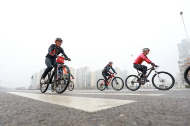 LUANNAN COUNTY, Hebei Eyaleti, Çin - 23 Kasım 2019: Bisikletçiler bir yol bisikleti yarışması sahasında ilerlemeye çalışıyorlar.