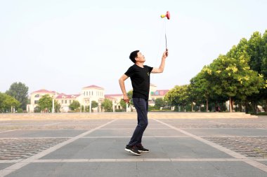 Luannan County, Çin - 12 Temmuz 2019: İnsanlar Diabolo 'yu Çin' in Hebei Eyaleti, Luannan County 'deki parklarda egzersiz yapması için sallıyor. Diabolo geleneksel Çin halk sporu yöntemlerinden biridir..