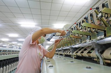 LUANNAN COUNTY, Hebei Eyaleti, Çin - 18 Mart 2020: İşçiler fabrikadaki dönen makineleri tamir ediyorlar.