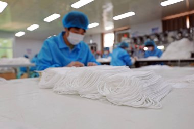 LUANNAN COUNTY, Hebei Eyaleti, Çin - 15 Nisan 2020: İşçiler tıbbi maske fabrikasının üretim hattında meşguller.