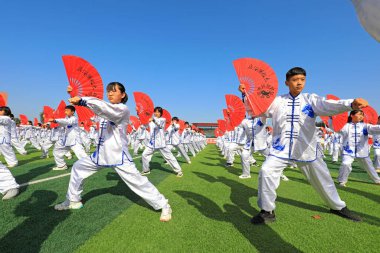 LUANNAN COUNTY, Hebei Eyaleti, Çin - 30 Eylül 2020: Ortaokul öğrencileri oyun alanında Taiji Fan pratik yapıyor