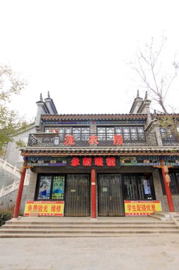 LUAN COUNTY - NOVEMBER 23: Shops along street in Luanzhou city, on november 23, 2014, Luan County, Hebei Province, China clipart