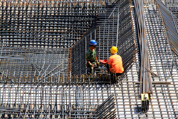 Construction workers making reinforced concrete frame in the construction sit