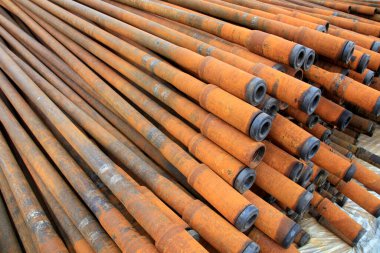 Oil pipe piled up together, closeup of photo clipart