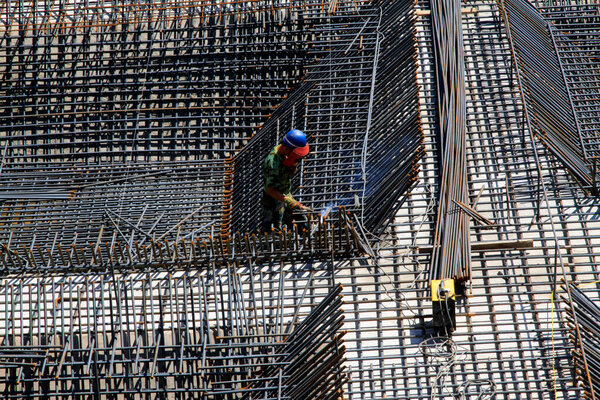 Construction workers making reinforced concrete frame in the construction sit