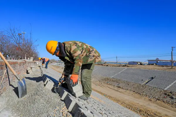 stock image Tangshan, China - December 24, 2021:Workers are building river slope protection at a water conservancy project construction site, North China