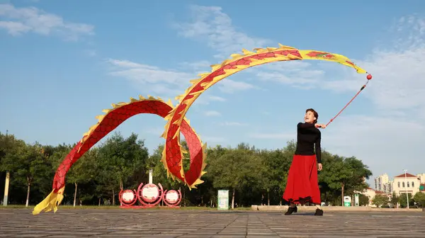 stock image LUANNAN COUNTY, China - September 14, 2021: people waving ribbons for fitness in the park, North China