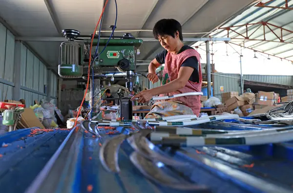 stock image LUANNAN COUNTY, China - September 14, 2021: Workers work hard on the sickle processing production line, North Chin