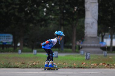 LUANNAN COUNTY, Çin - 2 Ekim 2021: Kuzey Çin 'deki park meydanında çocuklar paten antrenmanı yapıyor.
