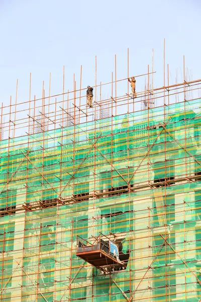 stock image LUANNAN COUNTY, China - November 15, 2021: construction workers build scaffolding at a construction site in North China