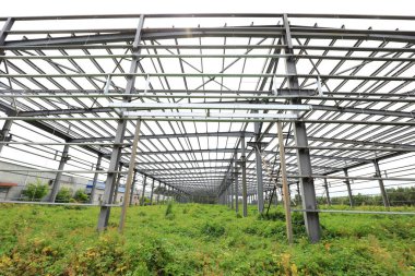 The steel beam framework of the plant is in the weeds clipart