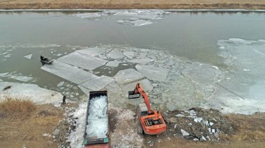 Workers use heavy trucks to transport ice, North China clipart