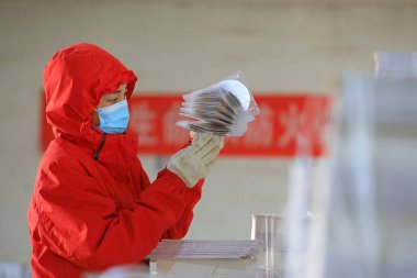 LUANNAN COUNTY, Çin - 24 Şubat 2022: İşçiler, Kuzey Çin 'deki okul için İngilizce CD' leri sayıyorlar