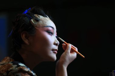 LUANNAN COUNTY, Çin - 11 Ağustos 2021: Pekin Operası aktörleri Kuzey Çin 'deki gösteri için dudaklarını çekiyorlar