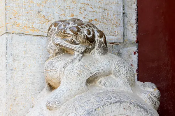 beast sculpture on the rock in a temple, closeup of photo