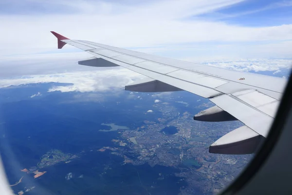 stock image Looking through window aircraft during flight in wing with a nice blue sky