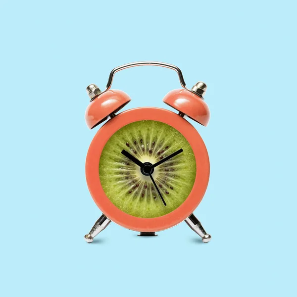 Alarm clock retro with kiwi fruit. Minimal pop atr fun poster about health care and time and deadline. High quality photo