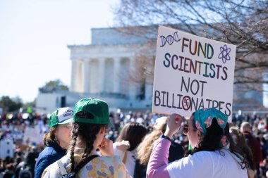 Göstericiler, 7 Mart 2025 'te Washington DC' de düzenlenen Stand-Up for Science mitinginde Trump yönetiminin bilimsel araştırma ve araştırmacıları kesmesini protesto etmek için Lincoln Anıtı 'nda toplandılar.