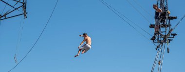 Sibiu City, Romania - 28 June 2022 trapeze artists acrobats from CirkVOST, on the metal scaffolding at the International Theatre Festival from Sibiu, Romania.