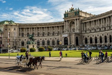 Vienna, Austria, September 28 2022 Hofburg palace and panoramic square view, people walking and fiaker with horses in Vienna, Austria clipart