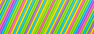 Close up many colored paper straw pattern background. Flat lay cocktail tube abstract vertical line texture. oblique orientation