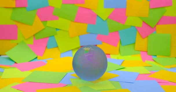 Rotating Crystal Ball Shaped Planet Earth Colorful Sticky Notes Background — Stockvideo
