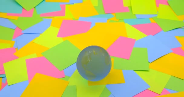 Rotating Crystal Ball Shaped Planet Earth Colorful Sticky Notes Background — Video Stock
