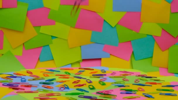 Multicolored Paper Clips Slowly Fall Multicolored Paper Sticky Notes Post — Stockvideo
