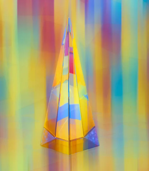 stock image crystal pyramid on Colorful sticky notes in background, motion blur