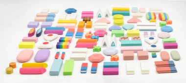 various shapes and colors of erasers arranged isolated on white background