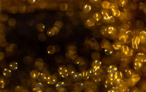 Golden sparkles on black background