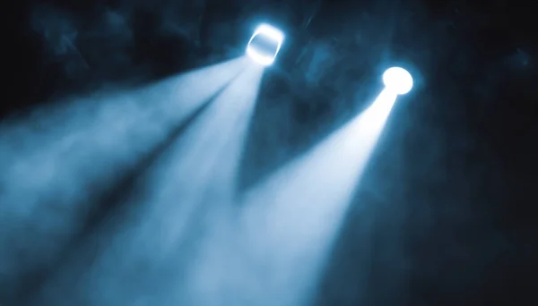 stock image projectors light beam through smoke on stage