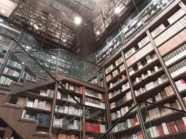 stock image Chongqing city, China - March 05, 2024. The unique interior design of Zhongshuge bookstore in Chongqing, using short stair cases and mirror in the ceiling to present magic geometric forms