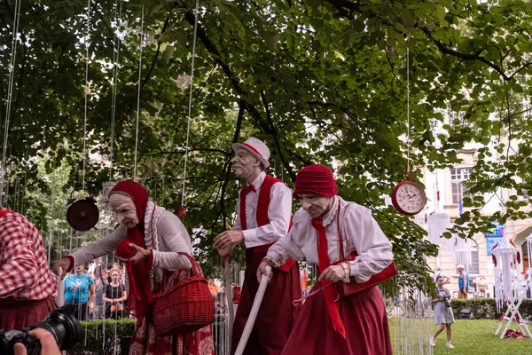 stock image Sibiu City, Romania - 23 June 2024.  street theater performance in the park, people with face masks