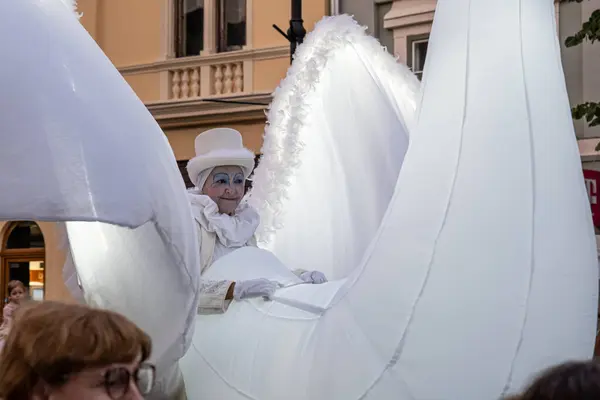 stock image Sibiu City, Romania - 01 July 2022. The street parade with artists in swan costumes during the International Theatre Festival from Sibiu, Romania.