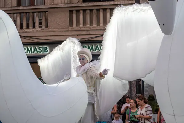 stock image Sibiu City, Romania - 01 July 2022. The street parade with artists in swan costumes during the International Theatre Festival from Sibiu, Romania.