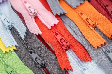 Multicolored Plastic Zippers or Zip Fasteners with sliders pattern for handmade sewing tailoring used for binding fabric or textile clipart